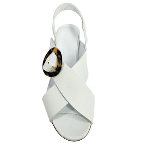 White leather slingback sandal with open toe, ankle strap, and tortoiseshell buckle
