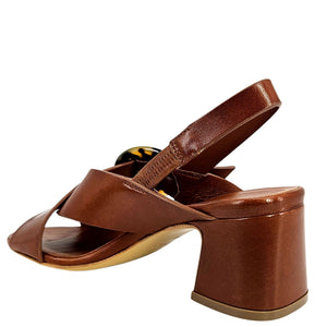 Cognac leather cross-strap sandal with block heel and round decorative buckle, angled view