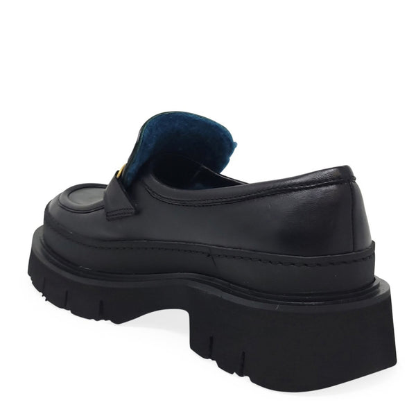 Black leather loafer with thick sole and blue shearling at the collar