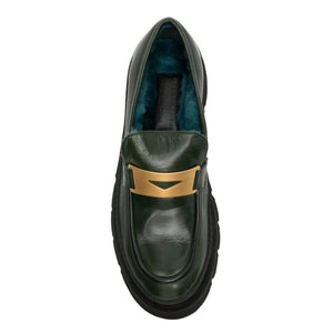 Green leather loafer top view with blue shearling lining and gold strap