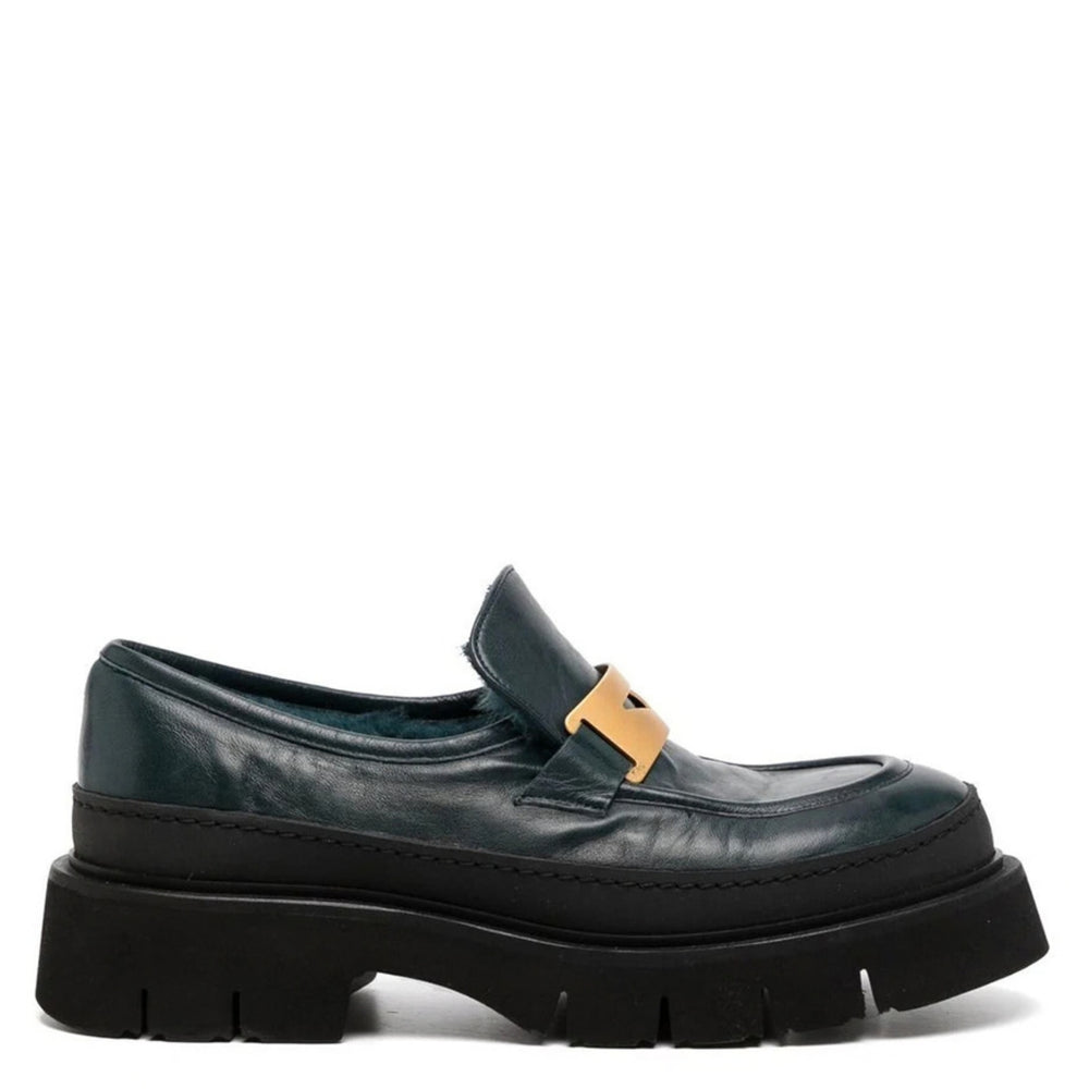 Chunky leather loafer with gold strap detail, dark shearling lining, thick black sole