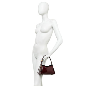 Dark berry patent-leather mini handbag on crossbody strap with gold-tone hardware