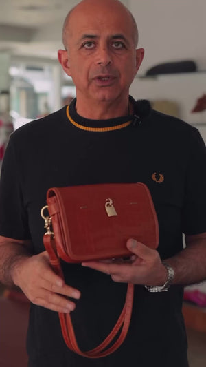 video of owner talking about quality and craftmanship of handbags 