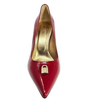 Red patent pointed-toe pump with stiletto heel and gold lock buckle detail