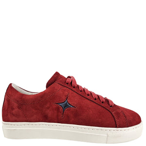 Red suede low-top sneaker with lace-up eyelets and blue star side logo