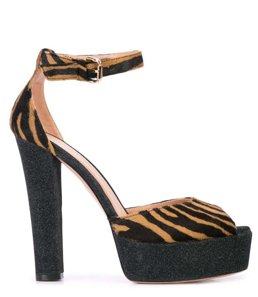 Zebra-print platform heel sandal with ankle buckle strap and tall black heel