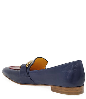 Blue two-tone flat loafer with gold chain detail, red inset, low wooden heel