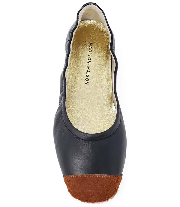 Black ballet flat with tan insole and tan calf-hair toe tip