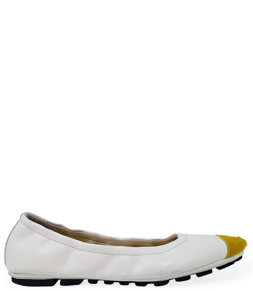 White ballet flat with yellow calf-hair toe tip and black sole
