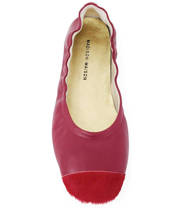 Red ballet flat with beige lining and fuzzy calf-hair toe trim, low sole