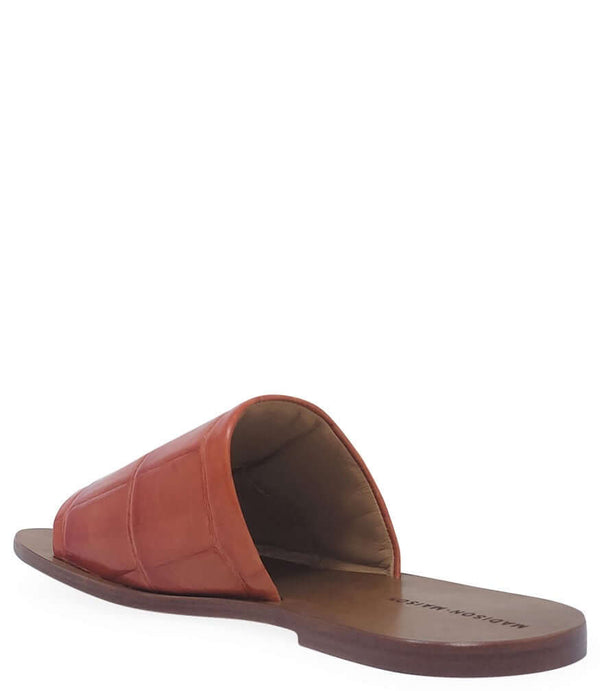 Orange leather open-toe slide sandal with contoured footbed and flat sole