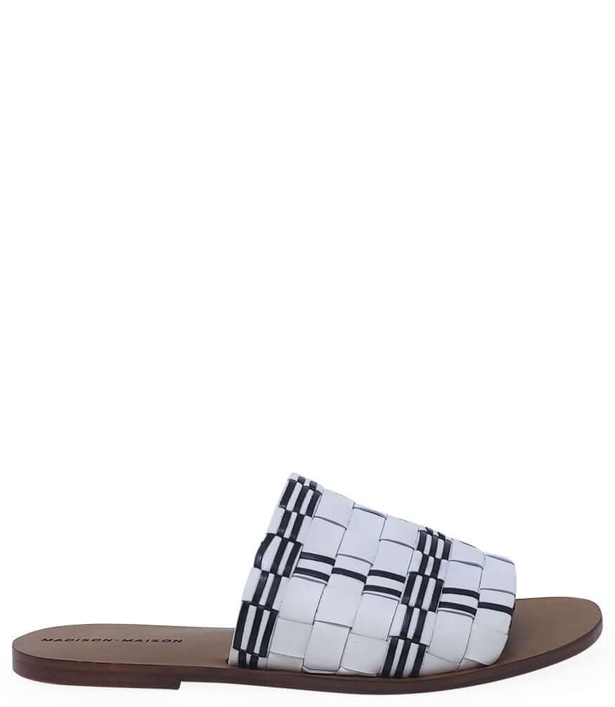 Open-toe flat sandal with white-and-black woven strap upper
