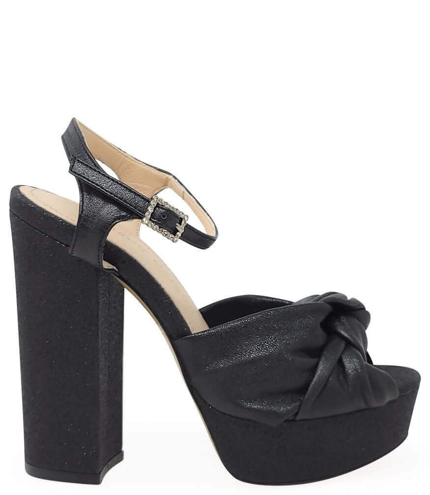 Black glitter platform heel sandal with ankle strap and bow detail