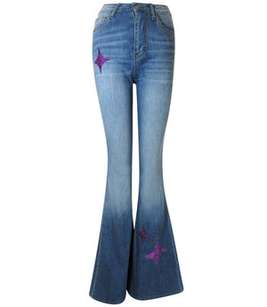 Light blue denim bell-bottom jeans with purple glitter star patches at legs