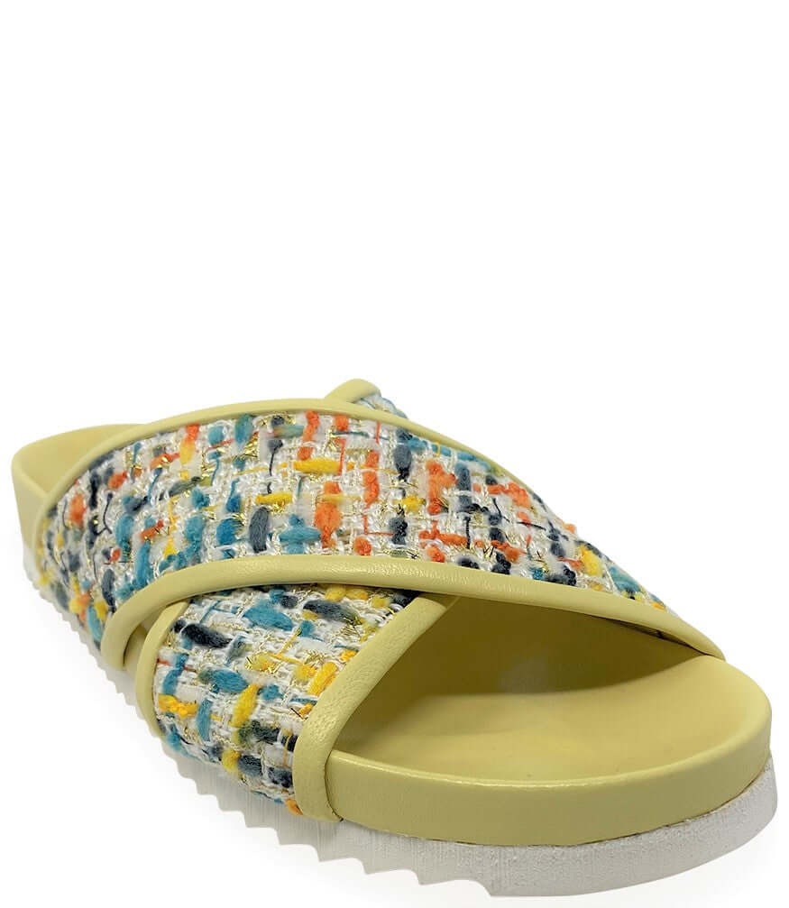 Yellow slide cross sandal with multicolor woven straps and textured footbed
