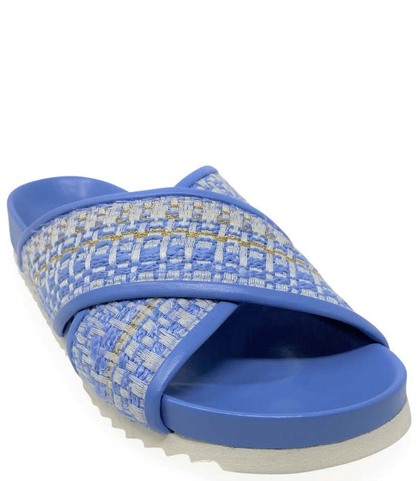 Sky blue slide sandal with crisscross straps, woven upper, and grippy textured sole