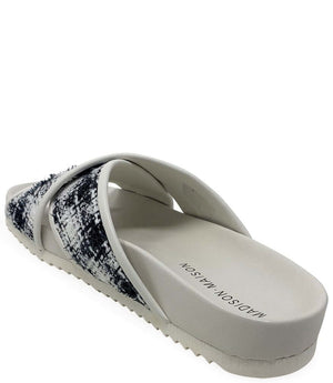 Cross-strap slide sandal with white/black patterned upper and white logo footbed