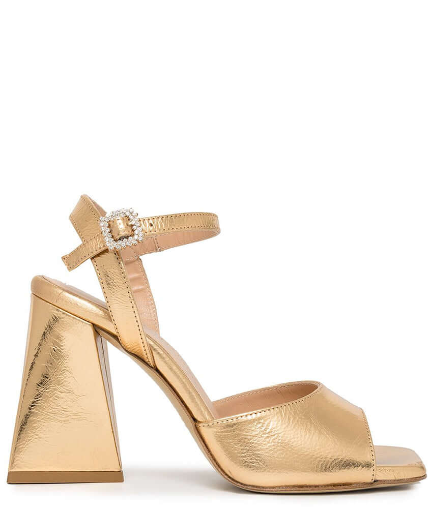Gold metallic leather triangle-heel sandals with ankle strap and jeweled buckle