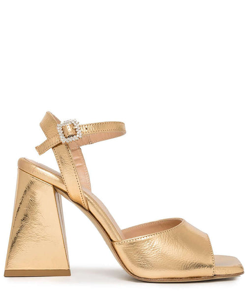 Gold metallic leather triangle-heel sandals with ankle strap and jeweled buckle