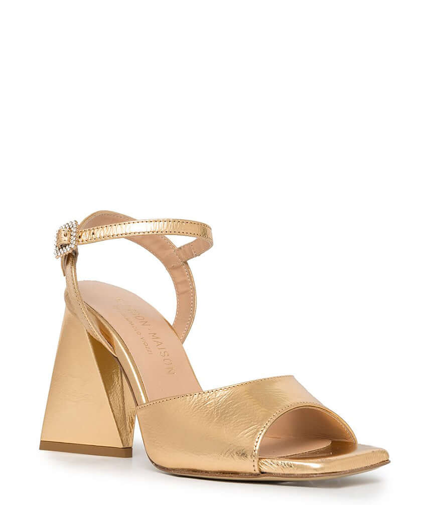 Gold metallic leather triangle-heel sandals with ankle strap and jeweled buckle